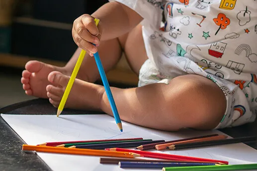 Child With Color Pencils Child coloring at 24 hour daycare centers
