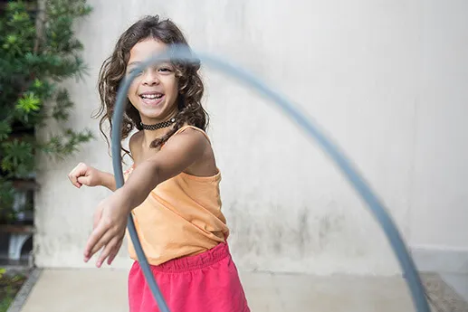 Developing Self-Help Skills Girl playing with hula hoop