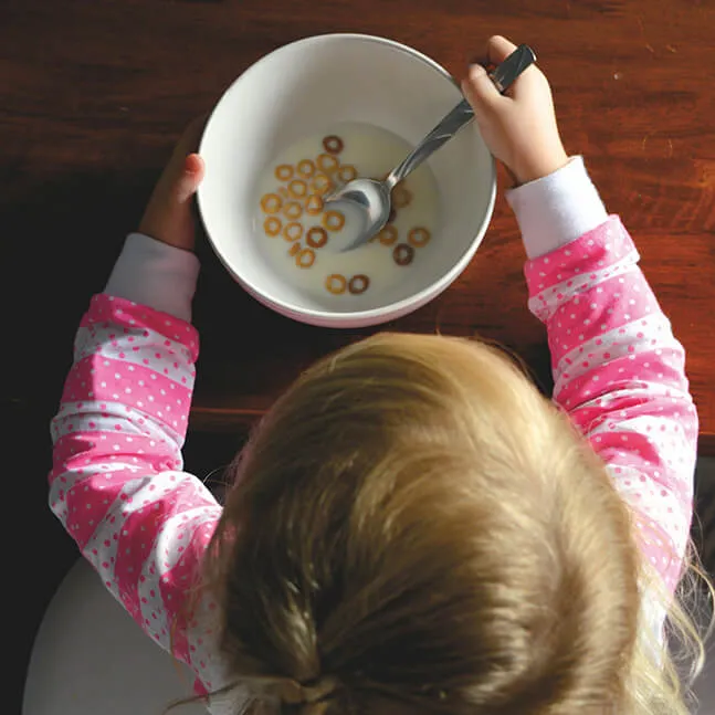 Overnight Care Program Toddler eating cereal