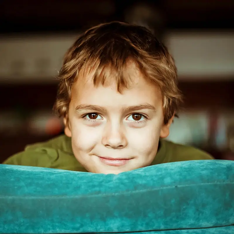 blue-sofa A young boy rests his read on a blue sofa