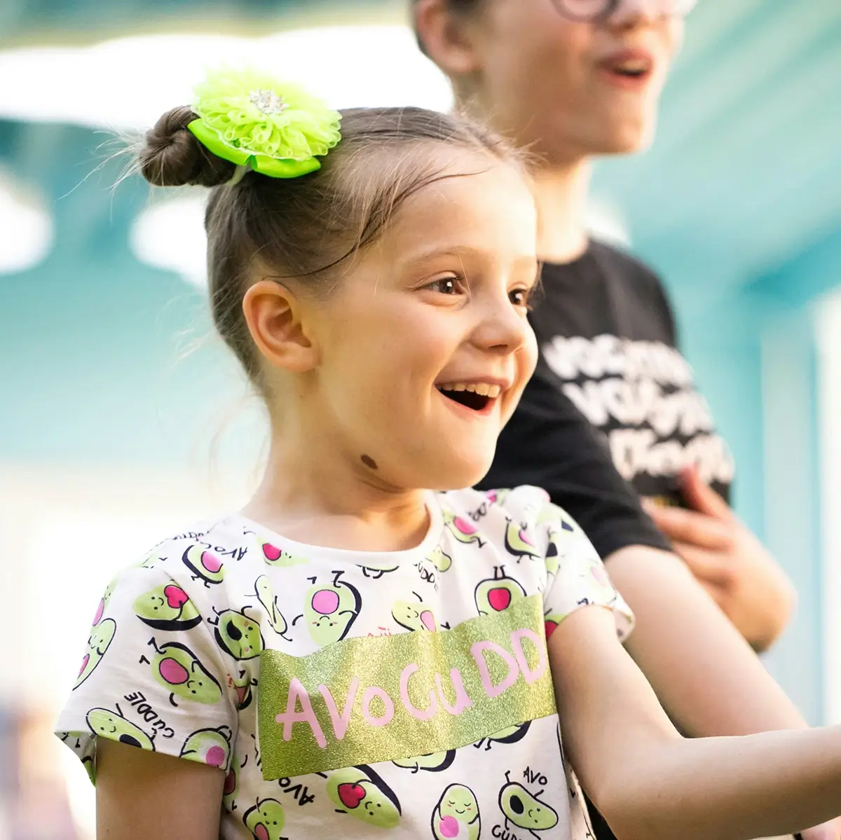 A girl smiling with her hand stretched outward