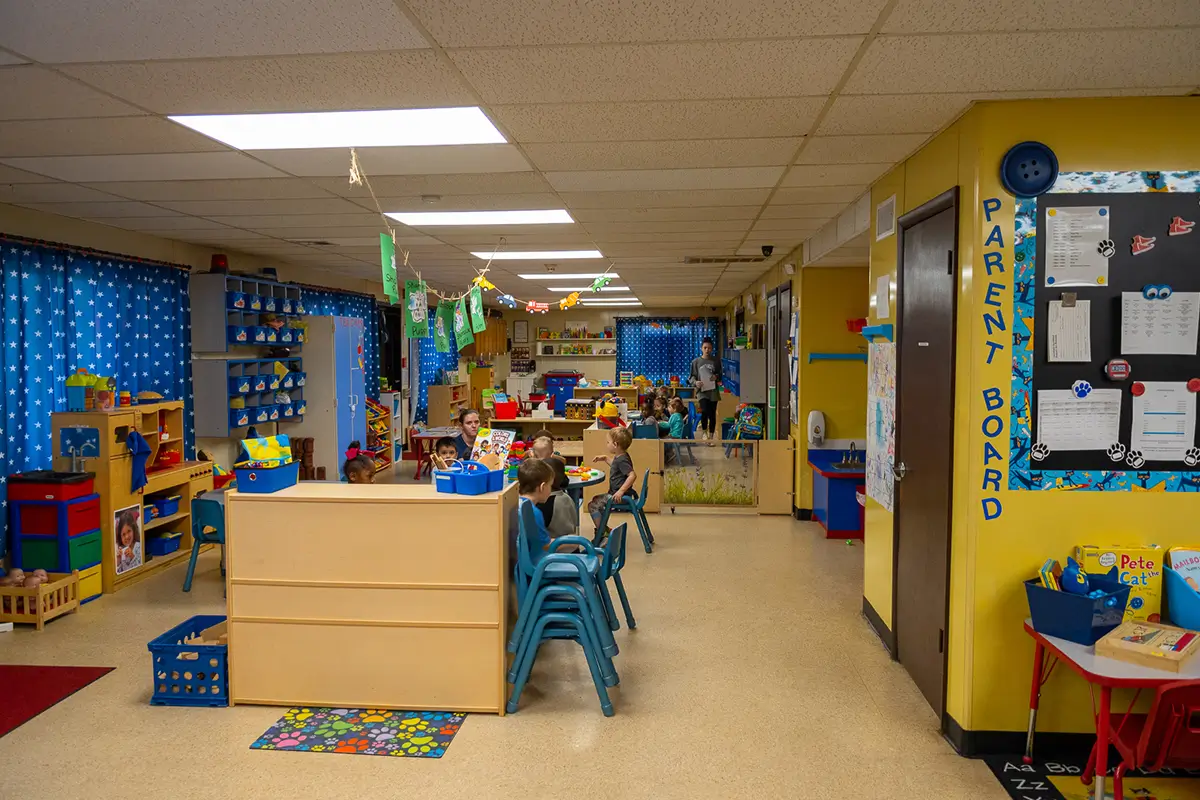Children engaged in play-based learning activities in a daycare classroom.